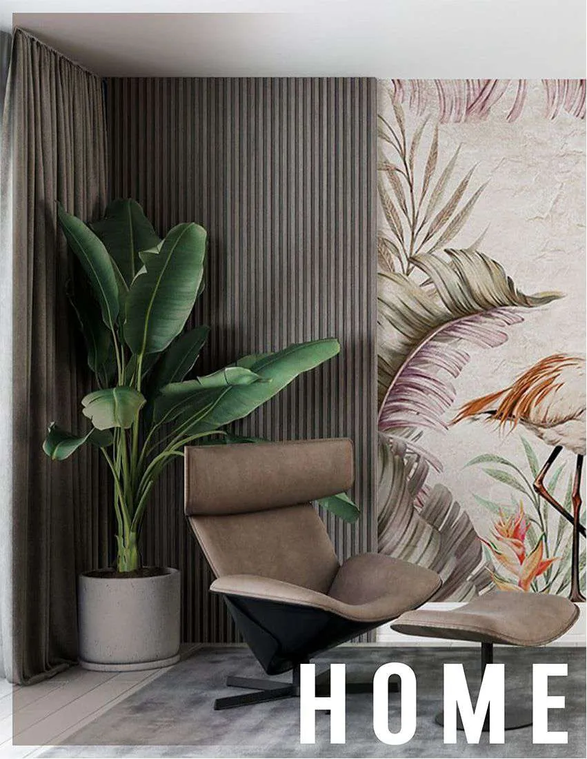 Home office corner with a tropical leaf mural beside a lounge chair and a tall plant