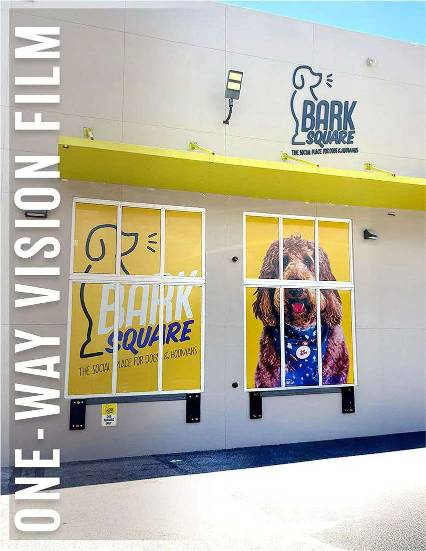 One-way vision film printed with dog artwork on the storefront windows of Bark Square