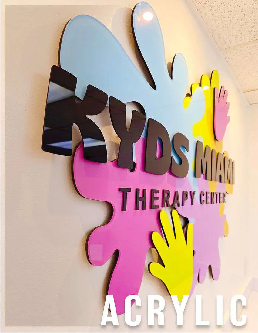 Acrylic sign for Kyds Miami Therapy Center with colorful cut-out letters and hands
